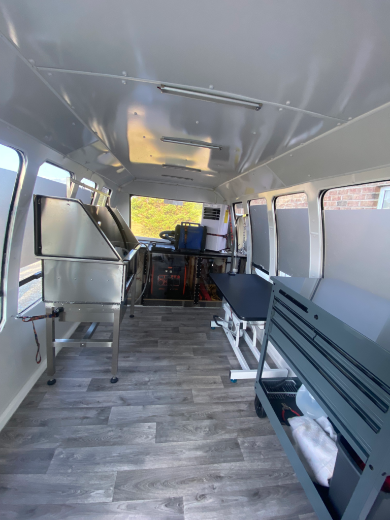 State-of-the-art mobile dog grooming salon interior showing stainless steel tub, grooming table, and professional equipment used by Express Mobile Pet Grooming Middle TN in West Nashville and surrounding areas.